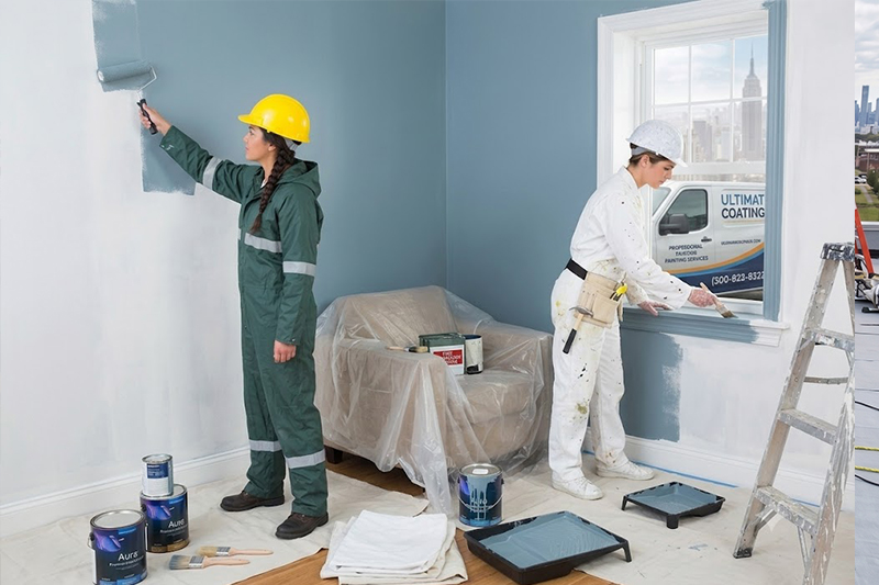 Technician painting an interior wall